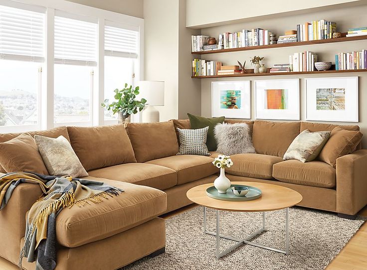 a living room scene with focus on the couch and coffee table in front of the window