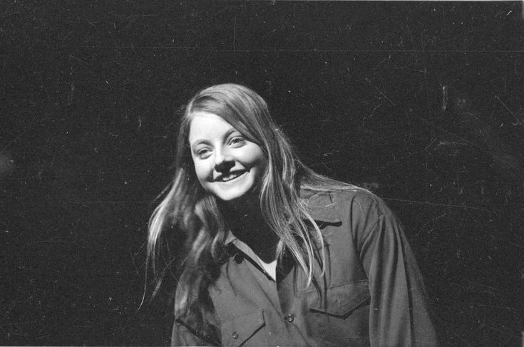 a black and white photo of a woman smiling