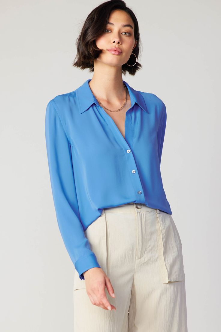 A classic button-up shirt is the kind of wardrobe staple you can style for almost any occasion. Designed to be worn with the collar undone, this long-sleeve silhouette has a relaxed fit with a shirttail hem and a single pleat at the back. It's versatile and effortless—an easy piece to dress up or down. •Pointed collar •Button front placket •Long sleeves •Relaxed fit •Shirttail hem Item number 2330278-1 100% Polyester Sleeve Silhouette, Woven Top, Trending Dresses, Item Number, Wardrobe Staples, Button Up Shirts, Button Down Shirt, Knitwear, Button Up