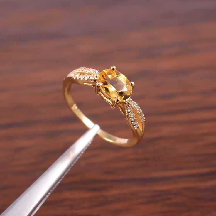 "Gemstone: Natural Citrine This ring features a 6x8mm oval cut Natural Citrine and sterling silver finished with yellow gold rhodium. It is made by hand. Product Description Main stone: Natural Citrine Access Stone : Cubic Zirconia Metal type: 925 sterling silver finished with yellow gold rhodium Rhodium nickel free Made In : Jaipur Rajasthan Payment Policy------------------------------ we accept payment through PayPal only, Payment should be made within 3 days of purchase. .Delivery Time------- Canning Peppers, Citrine Wedding Ring, Oval Sapphire Engagement Ring, Yellow Citrine Ring, Citrine Ring Engagement, Faberge Jewelry, November Birthstone Ring, Citrine Jewelry, Yellow Gemstones