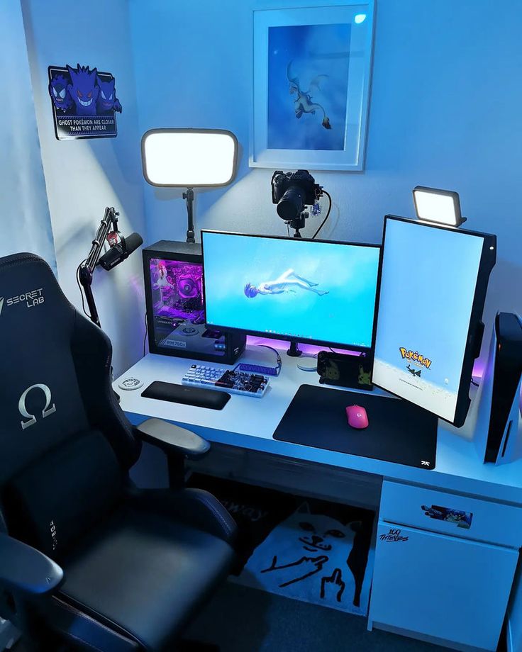 a computer desk topped with two monitors and a keyboard next to a mouse on top of a chair