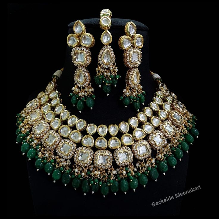 Designer elegant kundan necklace set handcrafted with premium kundans & cat eye beads > Premium quality kundan with back meenakari > For any colour customization please message us Inspired By Sabyasachi Wedding Kundan jewelry Such intricate detailing in this Inspired Heritage Royal Set with Green Emerald drops and Flawless Polki and Diamond work. This set will surely make heads turn .. Finest Kundan work . Emerald Green Bridal Jewelry Indian, Bridal Choker Set, Kundan Jewellery Bridal, Kundan Jewellery Set, Kundan Choker, Bridal Choker, Bridal Necklace Set, Polki Jewellery, Choker Necklace Set