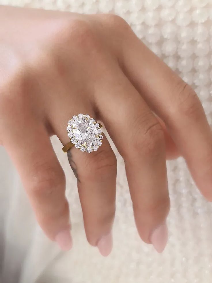 a woman's hand with a diamond ring on it