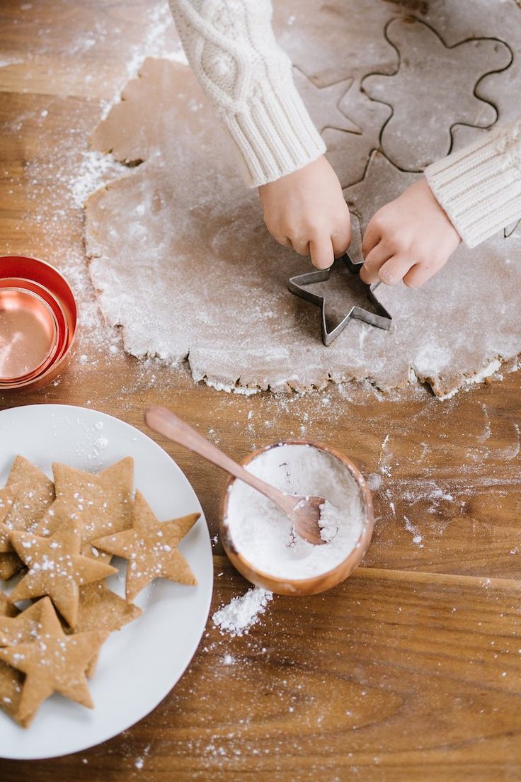 a person is decorating cookies on a table