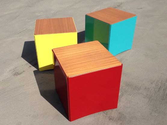 three different colored cubes sitting on the ground