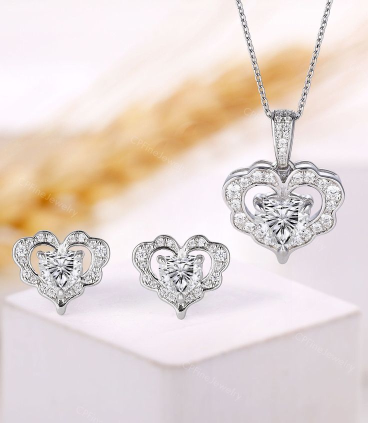 -----------Ring Information----------- Item: Heart Necklace Metal: 10K/14K/18K Solid Gold Necklace ▲Center Stone: Moissanite ▲Shape: 7 mm Heart Cut ▲Side Stone: Moissanite ▲Shape: Round cut ▲Carat: approx 0.255 ct ▲Color: DEF ▲Clarity: VVS-VS ▲Pendant Weight: about 3.26 g ▲Pendant Size: 20.7*15.7 mm Earrings ▲Center Stone: Moissanite ▲Shape: 5 mm (2) Heart Cut ▲Side Stone: Moissanite ▲Shape: Round cut ▲Carat: approx 0.12 ct ▲Earrings Weight: about 2.78 g ▲Earrings Size: 11.55*10 mm ------------- Diamond Jewelry Sets For Gifts, Fine Diamond Jewelry Sets For Gift, Fine Diamond Jewelry Sets As Gifts, Cubic Zirconia Jewelry Sets For Anniversary, Diamond White Jewelry Sets With Diamond Accents For Gift, Anniversary Jewelry Set With Cubic Zirconia Pendant, Anniversary Cubic Zirconia Jewelry Sets With Pendant, Anniversary Cubic Zirconia Pendant Jewelry Set, Elegant Cubic Zirconia Jewelry Sets For Valentine's Day