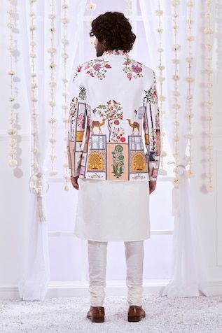 White full sleeves bandhgala crafted in 100% silk with Moroccan Kalamkari embroidery. Paired with a solid white kurta and a churidar. - Aza Fashions Designer Long Sleeve Bandhgala For Diwali, Designer Long Sleeve Kurta For Festivals, Traditional Bandhgala With Long Sleeves And Printed Motifs, Traditional Bandhgala With Printed Motifs For Festive Occasions, Traditional Long Sleeve Bandhgala With Printed Motifs, Long Sleeve Bandhgala With Printed Motifs For Eid, Fitted Bandhgala With Printed Motifs For Diwali, Designer Nehru Jacket With Long Sleeves For Diwali, Diwali Fitted Bandhgala With Printed Motifs