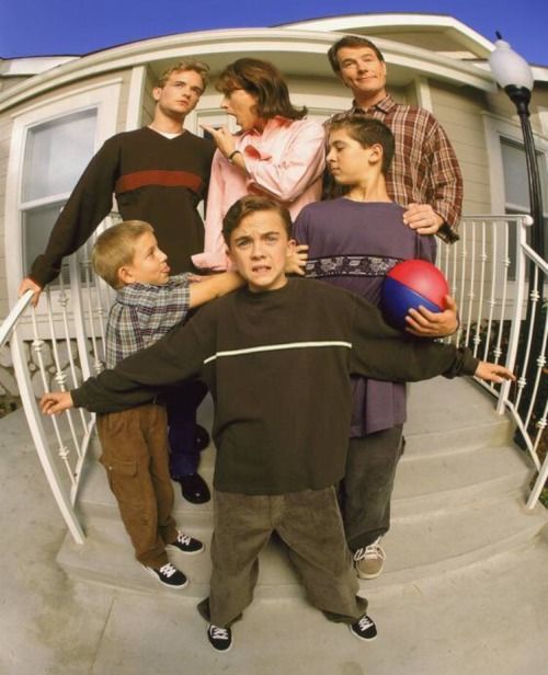 a group of people standing on top of a stair case next to each other with a ball in their hands