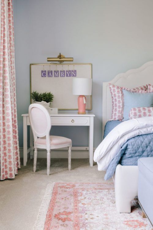 a bedroom with blue walls and pink accents