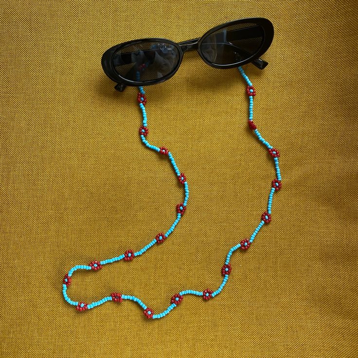 Level up your style with this boho beaded sunnies chain! Whether you are running errands, at the beach, in carpool, or traveling, this glasses chain is a safe (and trendy) way to keep your glasses secure and nearby. Imagine knowing your glasses are not getting scratched in your bag or having your hands free when you take off your shades... sounds nice right?! Summer Blue Glasses Chain With Adjustable Feature, Blue Adjustable Chain Glasses Chains For Summer, Blue Adjustable Glasses Chain For Summer, Red Bohemian Beaded Necklace For Summer, Summer Bohemian Red Beaded Necklaces, Summer Red Bohemian Beaded Necklaces, Summer Red Bohemian Beaded Necklace, Summer Bohemian Red Beaded Necklace, Trendy Turquoise Beaded Necklaces