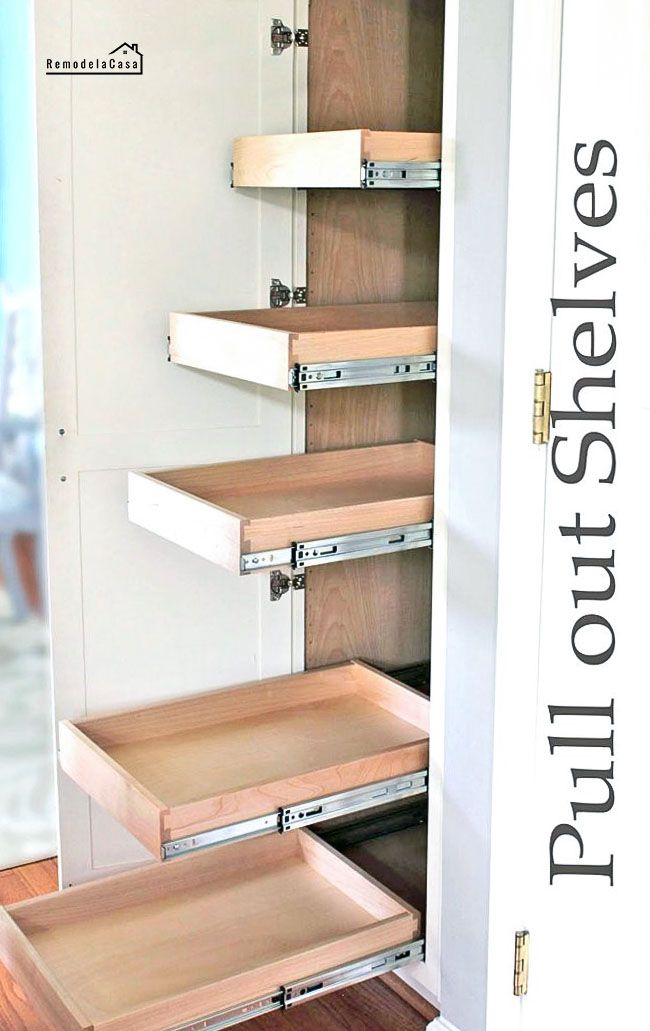 an open closet door with drawers on the bottom and bottom shelves in front of it