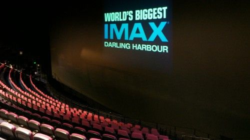 the inside of an auditorium with rows of seats and a projection screen that says world's biggest imax