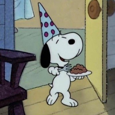 a cartoon dog with a birthday hat holding a plate of cake in front of him