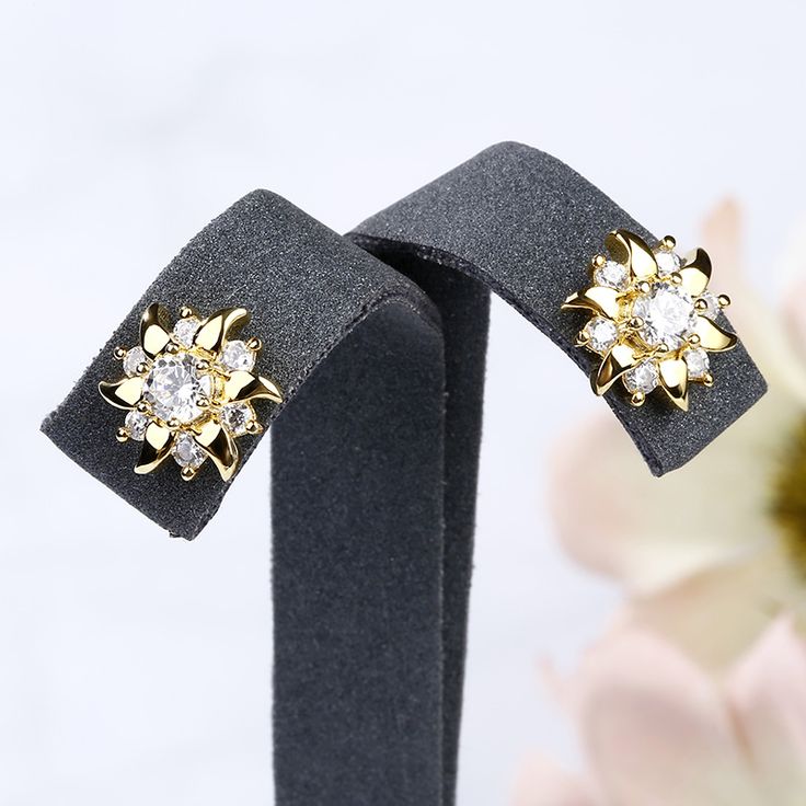 Inspired from sunflower,this pair of stud earrings shows a lovely look with its yellow gold tone. The pistil is set with a 4mm white Jeulia® Stone and six small stones decorate the petals, which make the earrings glistening flowers. They are good gifts for yourself, frinends or sisters. Never miss the little lovely thing!Carat Weight: 1.33 ctStone Size: 4,2 mmNumber of Stones: 14 Stone Shape: RoundStone Color: Diamond WhiteWeight: 2.7 gWidth: 10 mmHeight: 10.7 mmThickness: 3.6 mmMaterial: 925 Si Yellow Gold Plated Flower Earrings For Anniversary, Gold Flower-shaped Cluster Earrings With Prong Setting, Gold Cluster Earrings With Flower Shape, Gold Flower Cluster Earrings With Prong Setting, Classic Gold Cubic Zirconia Flower Earrings, Classic Gold Flower Earrings With Cubic Zirconia, Gold Flower-shaped Cluster Earrings With Cubic Zirconia, Gold Flower-shaped Cubic Zirconia Cluster Earrings, Gold Cubic Zirconia Flower Cluster Earrings