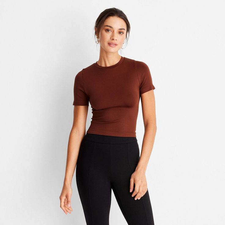 This Seamless Jersey Crop Top from A New Day™ in a solid colors offers easy pairing with a range of looks. Fashioned in a cropped length, it features a classic crewneck and a slim silhouette to give you a fitted look. The lightweight fabric with added stretch and a seamless design offers a more comfortable fit, and you can wear it with your choice of bottoms to create a range of versatile styles. . A New Day™: Style that goes wherever you do. Basic Stretch Cropped T-shirt For Loungewear, Fitted Casual Cropped T-shirt For Fall, Basic Cropped T-shirt For Loungewear, Fitted Solid Brown Tops, Fitted Brown Solid Color Top, Solid Color Ribbed Short Sleeve Stretch Top, Stretch Crew Neck Cropped T-shirt, Fitted Seamless T-shirt For Loungewear, Solid Ribbed Stretch Short Sleeve Top