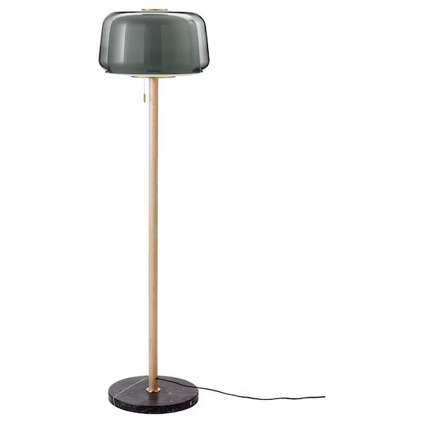 a lamp that is sitting on top of a table next to a white wall and floor