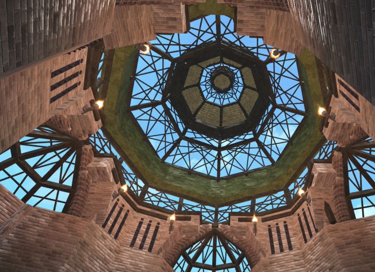 the inside of a large building with many windows and lights on it's ceiling