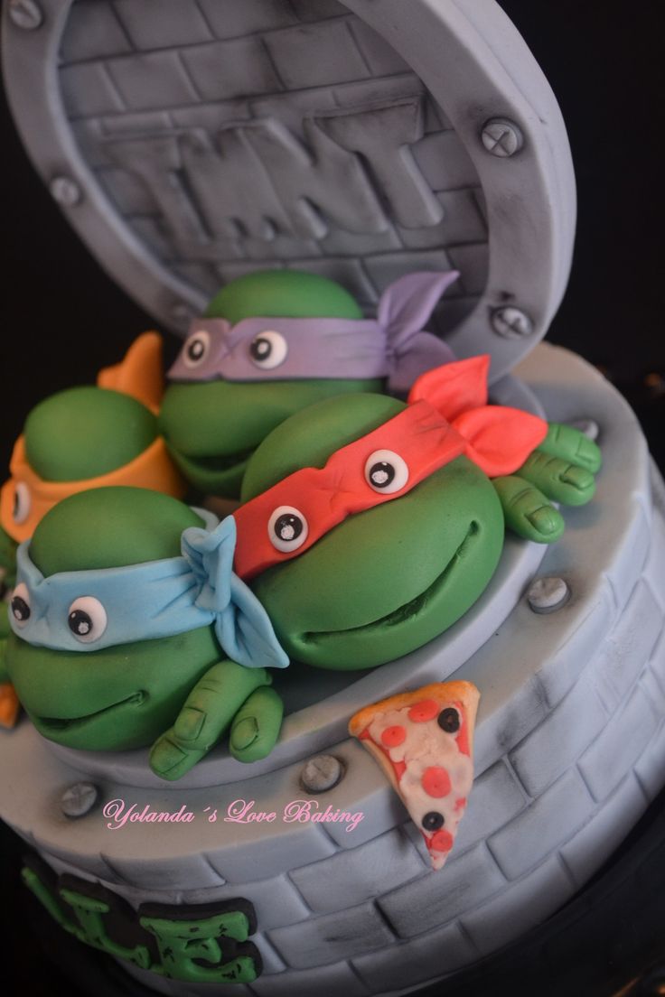 there is a cake decorated to look like teenage mutant turtles