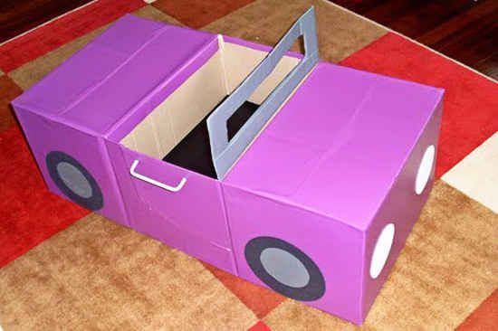 a purple cardboard box sitting on top of a floor