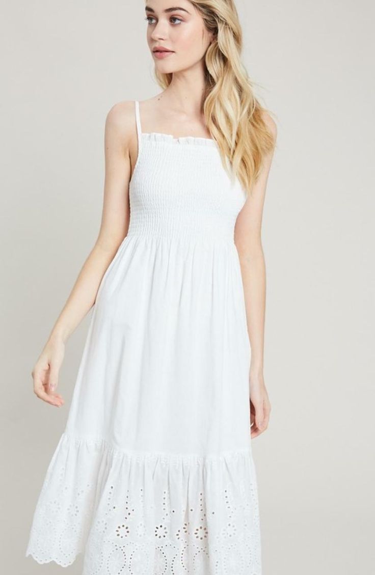 From beach days to a village stroll, all eyes will be on you in the adorable Summer Sun White Smocked Midi Dress! Adjustable tank straps top this sweet midi made from ivory white lightweight woven fabric. A square neckline and stretchy smocked bodice top a flowy midi skirt with an eyelet lace ruffle hem. DETAILS & CARE Cotton. Dry Clean. Imported. ORDERS, SHIPPING & RETURNS Orders, Shipping, & Returns Affordable White Smocked Dress, White Sun Dress Midi Boho, Cute White Smocked Dress Affordable, Cheap Sleeveless Smock Sundress, Affordable Smocked Sundress For Summer, Affordable Summer Midi Dress With Smocked Bodice, Cheap Sundress With Smocked Back For Brunch, Cheap White Sundress For Play, Luxury Fitted Smocked Midi Dress