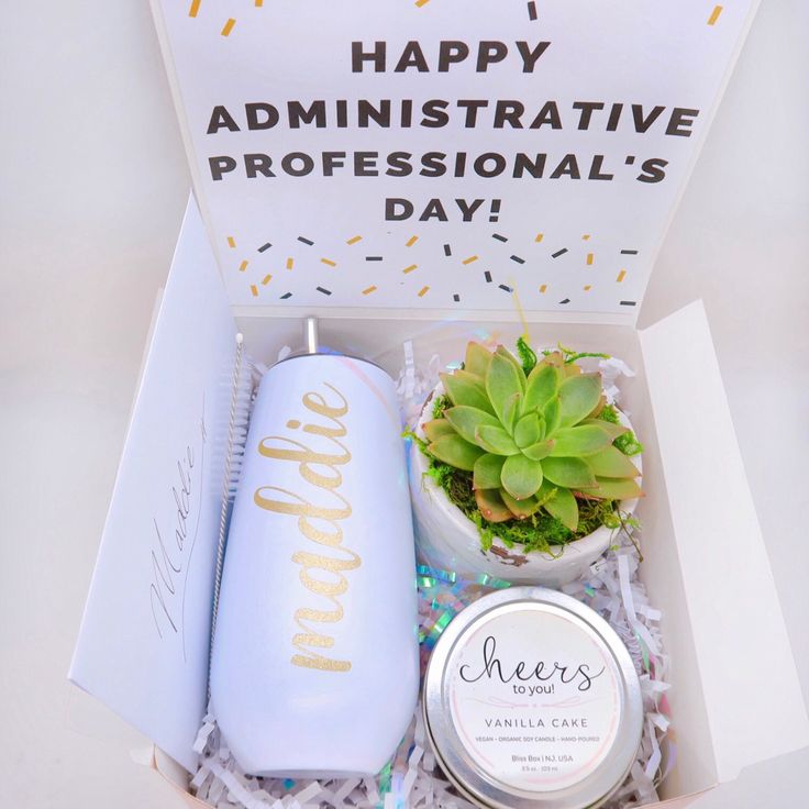 an open box containing a plant, candle and some confetti on the table