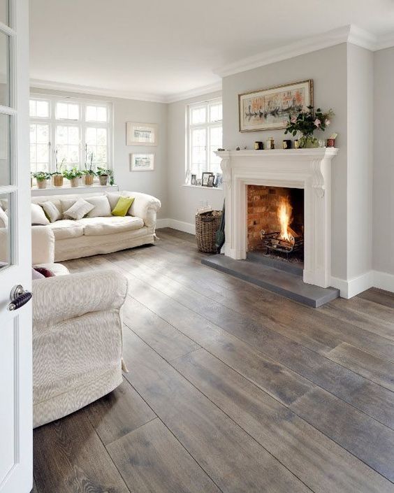 a living room filled with furniture and a fire place