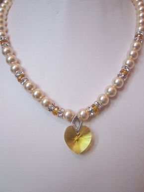 What a Beautiful Pearl Necklace! Swarovski crystal pearls are accented with silver/rhinestone decorative crystal beads, 8mm rondelles and features a Swarovski Golden Yellow18mm heart. It will add a touch of glamour and elegance to any occasion. Perfect for the bride, bridesmaids, Valentine's Day Wedding Beaded Jewelry, Heart-shaped Beaded Wedding Necklaces, Wedding Heart-shaped Beaded Necklaces, Valentine's Day Wedding Pearl Drop Necklace, Elegant Pearl Necklace With Heart Beads For Wedding, Pearl Necklace For Wedding On Valentine's Day, Wedding Pearl Necklace With Heart Beads, Wedding Pearl White Heart Pearl Necklace, Elegant Wedding Pearl Necklace With Heart Beads