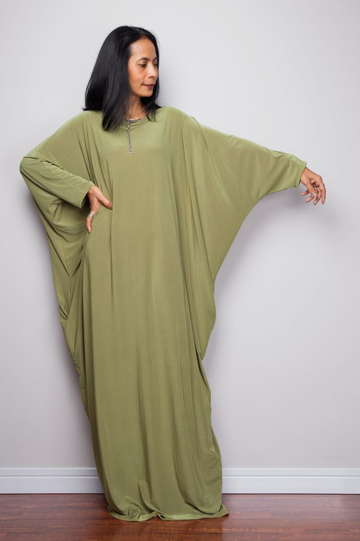 "Olive Green Kaftan Dress, Maxi Dress, Long boho dress, Loose fit dress, Modest dress, Green kaftan with pockets PRODUCT SIZE : One Size Fits Most * Chest : free up to 58\" * Waist : free up to 58\" * Hips : free up to 58\" * Circumference bottom hem : 45\" * Length : 56\" * Sleeve length : 23\" MATERIAL * Spandex Venetia * Zipper on the back MODEL : * Model chest : 32\", Height 160 cm (5.2) without high heel * Accessories excluded Produced by NUICHAN IMPORTANT NOTE *Please note that colours sho Casual Oversized Dresses With Batwing Sleeves, Green Flowy Long Sleeve Tunic, Oversized Green Tunic For Spring, Oversized Green Dress For Beach, Free Size Green Maxi Dress, Casual Flowy Maxi-length Tunic, Green Free Size Maxi Dress, Oversized Batwing Sleeve Maxi Dress For Spring, Oversized Long Sleeve Lagenlook Maxi Dress