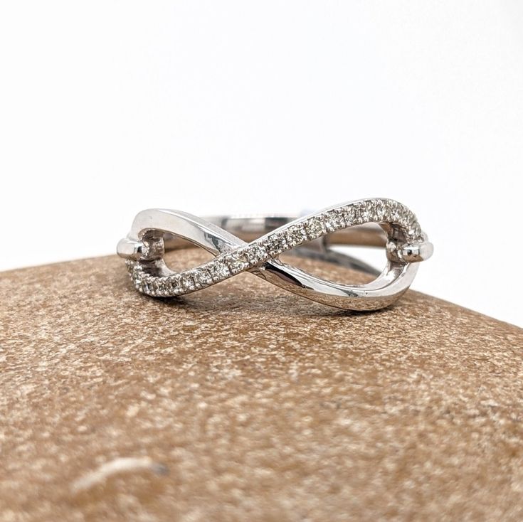 This infinity sign band is perfect for wearing by itself or stacking with other rings or bands! The occasions to show off this band are endless - Valentines day, mother's day, graduation, wedding, birthday, date night, Christmas, etc. :) Modern Twist Infinity Stackable Rings, 14k White Gold Infinity Diamond Ring, Infinity Shaped Stackable Promise Ring Jewelry, Infinity Promise Jewelry With Diamond Accents, Infinity Shaped Promise Jewelry With Diamond Accents, Infinity Jewelry With Diamond Accents For Promise, Fine Jewelry Infinity Stackable Pieces, Adjustable Infinity Stackable Rings With A Modern Twist, Stackable Infinity Promise Ring