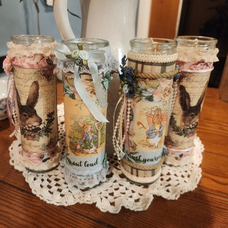 four glass mugs are sitting on a doily