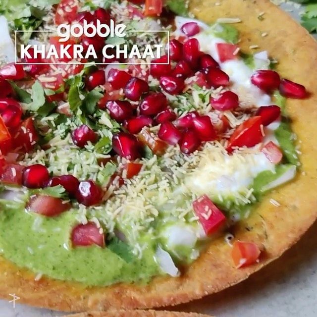 a close up of a pizza with toppings on it and the words goodbye khakra chaati