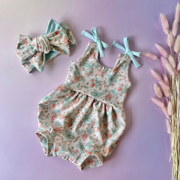 Get ready for some fun in the sun with this bubble romper, made of stretchy cotton lycra fabric. Perfect for hot summer days, it has cute shoulder tie straps and a snap closure bubble bottom. Plus, it makes a great baby shower gift with its perfect blend of style and comfort. Don't forget to top off the look with an oversized bow headband! 🧺Care: Cold machine wash Line dry As each piece is unique, print position may vary slightly.  Shipping within Australia is a flat rate of $10 with a tracking Cute Printed Sleeveless Jumpsuits And Rompers, Playful Printed Sleeveless Jumpsuits And Rompers, Spring Playtime Sleeveless Onesie, Cotton Jumpsuits And Rompers With Tie Straps For Summer, Sleeveless Summer Onesie, Summer Cotton Jumpsuits And Rompers With Tie Straps, Spring Playful Printed Bubble Romper, Cute Printed Summer Jumpsuits And Rompers, Summer Bubble Romper For Spring Playdate