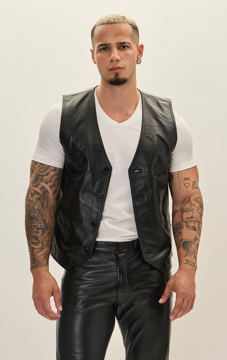 Crafted from premium leather, this vest boasts durability and a luxurious feel. The leather is typically sourced from high-quality hides, ensuring a supple texture and robust performance. The stitching is often reinforced for longevity, emphasizing both style and functionality. Ideal for both casual and semi-formal occasions, the leather vest can be dressed up with a crisp shirt and trousers or dressed down with a T-shirt and jeans. Its timeless appeal makes it suitable for various seasons, offering warmth during cooler months while remaining breathable. SIZE + FITTailored fit, to find your correct size use the ''what's my size '' button. COMPOSITION 100% Lambskin LeatherMade in TurkeyStyle #: 51094CARESpecialist Leather Clean Only Classic Fitted Leather Vest, Sleeveless Leather Outerwear For Biker Events, Classic Sleeveless Leather Vest, Fitted Leather Vest For Fall, Fitted Leather Vest For Business, Luxury Black Vest For Fall, Sleeveless Black Leather Jacket For Fall, Fitted Sleeveless Leather Outerwear, Fitted Sleeveless Leather Jacket