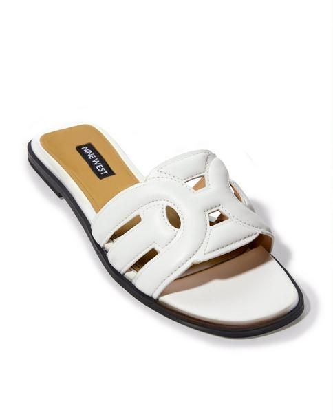 Simply slip on this comfy slide sandal and go, with its flat heel, lightly padded sole, and stylish faux leather upper. Perfect for pairing with your favorite bottoms or a chic sundress. This versatile shoe is a wardrobe must-have in neutral to colorful hues. | Boston Proper - White - Slide Sandal - 9.0 Modern Slip-on Summer Flats, White Cushioned Flats For Summer, Chic Slides For Summer Outings, Slide Flats For Spring Vacation, Chic Flat Slides For Summer Outings, Casual Slides With Flat Heel For Spring, Chic Slides With Textured Footbed For Spring, Summer Flats With Cushioned Footbed, Chic Flat Slides With Cushioned Footbed