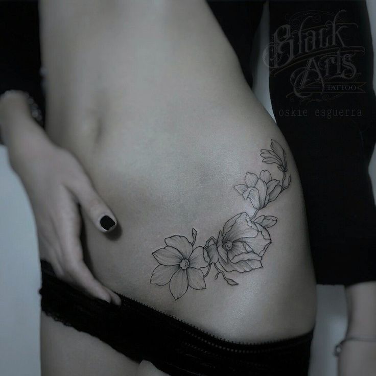 a woman's stomach with flowers on it and the bottom part of her belly