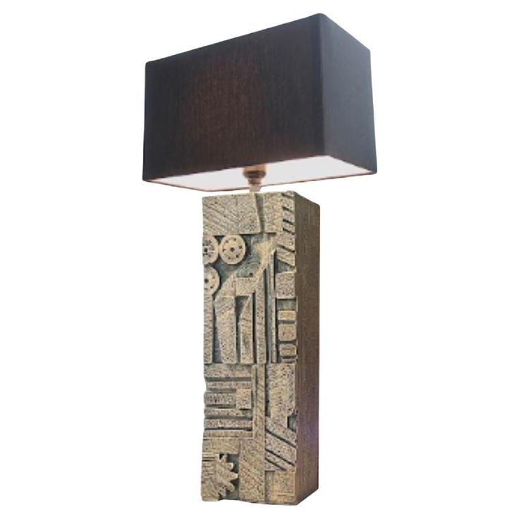 a lamp that is sitting on top of a wooden block with a black shade over it