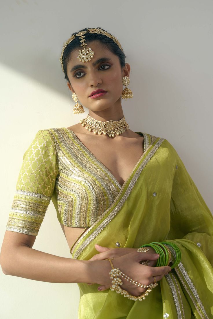 Introducing the exquisite elyse sari and blouse, a harmonious fusion of chanderi, organza, and chanderi silk fabrics in a resplendent lime green hue. This set features delicate trims, meticulous cutwork, and masterful handwork. Elevate your elegance with this ethereal ensemble, designed to enchant and inspire at any grand occasion. Floral Blouse Designs, Lime Green Blouse, Green Blouse Designs, Green Sari, Sequin Saree, Blouse Designs Silk, Sequin Embroidery, Green Saree, Blouse For Women