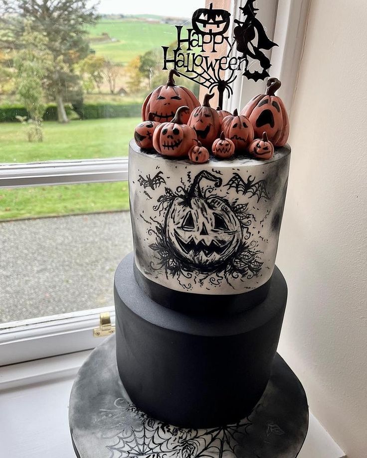 a three tiered halloween cake with pumpkins on the top and black icing