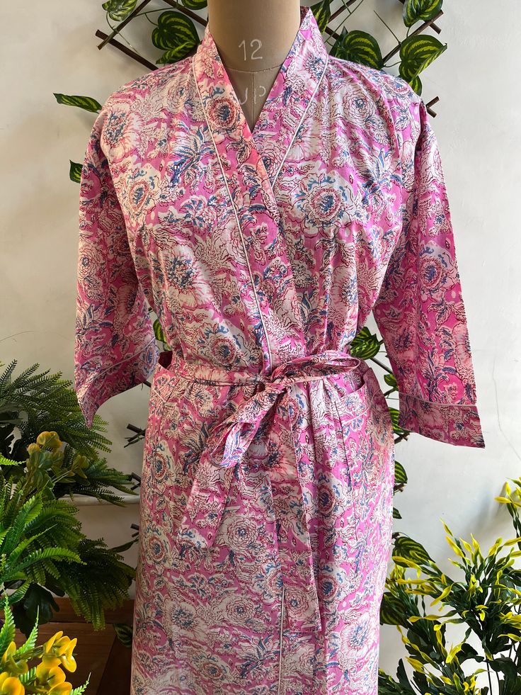 Cotton kimono robes are perfect for lounging around the home or spa. Use our floral printrobe as a cover up on the beach or after a dip in the pool. Add a luxe, boho feel to your bridal shower. Versatile, soft and luxurious, our 100% cotton kimono robes are printed with azo-free dyes. The print floral robe features 3/4th sleeves, a waist tie and two front pocket. Size - One size will fit all sizes S to XL Length - 50 inches (125Centimeter), Measurements Approx : *Length: 50" Inches *Bust Around Size: 48" Inches *Shoulder: 8" Inches *Sleeve Length: 14" Inches *Sleeve hole: 9" Inches *2 Side Pockets For best results hand wash and line dry when possible. Machine wash cold, tumble dry low and warm iron. Floral Print Sleepwear With Kimono Sleeves, Pink Kimono For Home Use In Spring, Pink Kimono For Home During Spring, Pink Spring Kimono For Home, Wrap Kimono For Spring Wedding, Pink Sleepwear With Kimono Sleeves For Spring, Pink Kimono For Spring Wedding, Pink Floral Print Home Robe, Wedding Robe With Kimono Sleeves For Spring