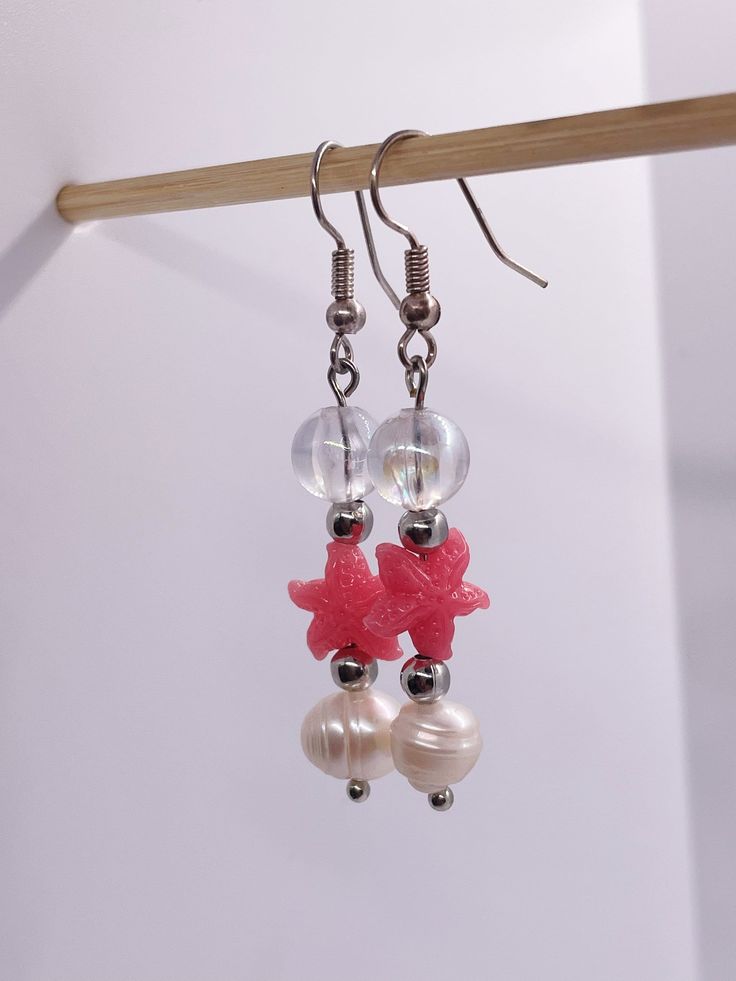 Make a splash with these stylish starfish earrings! 🌟 Whether you're strolling on the beach or attending a seaside soirée, these unique pearl dangles will add a touch of oceanic charm to any outfit. Dive into summer with these beachy beauties! Summer Pearl Earrings, Summer Beach Drop Earrings, Summer Pearl Earrings For Pierced Ears, Casual Star Jewelry For Summer, Casual Star-shaped Summer Jewelry, Casual Summer Star Shaped Jewelry, Summer Beach Dangle Earrings, Summer Pearl Drop Earrings, Trendy Summer Jewelry With Star Charm