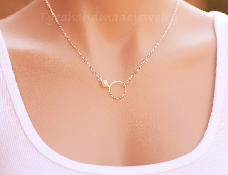 A karma circle and pearl necklace (or bracelet) with two metal/color choices: silver or gold 1. one small tiny birthstone of your choice (from the fourth photo) 2. a small sterling silver or 24k gold dipped over sterling sivler circle 3. a dainty yet sturdy sterling silver or 14k gold filled chain closed with a lobster clasp Packaged in a very presentable gift box (as shown). Please select metal type/jewelry type and length from the dropdown menu and leave your choice of stone beads in your chec Elegant Birthstone Necklaces, Dainty Silver Circle Jewelry, Elegant Circular Jewelry With Simple Design, Simple Silver Jewelry With Pearl Charm, Elegant Circle Jewelry With Simple Design, Elegant Open Circle Jewelry With Simple Design, Dainty Open Circle Wedding Jewelry, Simple Silver Jewelry For Bridesmaid Gift, Simple Round Pearl Jewelry