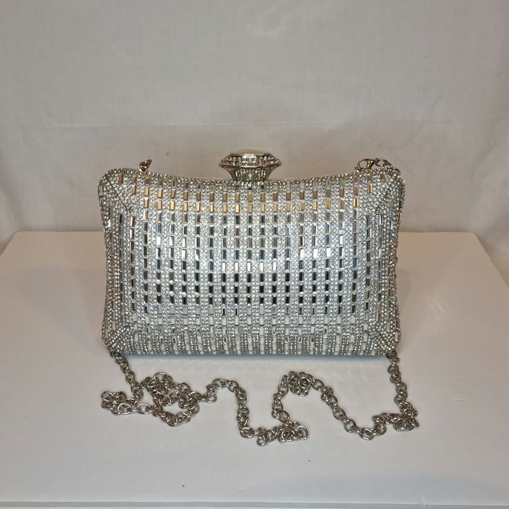 Womens silver mirror crystal diamond embellished evening clutch bag with silver embellishment, metallic satin finish material and crystal detailed top closing clasp Can be used with or without long shoulder chain (included) size approx- H 12cm x W 20cm Free Royal Mail delivery is an estimated 3-5 days but this can occasionally be slightly longer which solely on the Royal Mail side. We do offer guaranteed next day delivery but please contact us prior to ordering as this would incur a small upgrad Glamorous Silver Sparkling Bag, Silver Crystal Bag For Party, Glamorous Sparkling Silver Bags, Silver Crystal Party Bag, Formal Metallic Silver Rectangular Bag, Evening Bags With Silver Accents, Rectangular Shape, Silver Sparkling Evening Bags, Silver Sparkling Bags For Evening, Silver Clutch With Rhinestones