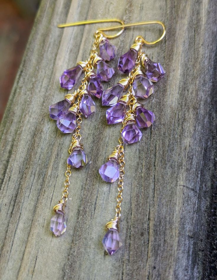 These uniquely shaped tumble drop amethyst stones are bright and clear. They swing around and reflect light in an eye catching way. They measure 3.125" from the top of the ear wire. Wrapped in gold filled wire. Wire Wrapped Amethyst Drop Earrings, Purple Teardrop Wire-wrapped Earrings, Purple Wire Wrapped Drop Earrings, Purple Teardrop Wire Wrapped Earrings, Faceted Teardrop Amethyst Jewelry, Lavender Teardrop Jewelry With Ear Wire, Purple Long Drop Jewelry With Ear Wire, Teardrop Faceted Amethyst Jewelry, Teardrop Amethyst Jewelry With Faceted Detail