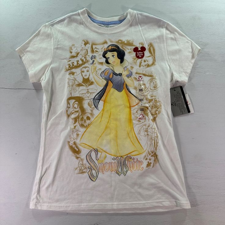 This Vintage Disney Store Studio Collection Snow White Sketch Tshirt Is A Must-Have For Any Disney Fan. The Beige Color And Solid Pattern Make It A Versatile Addition To Any Wardrobe. The Short Sleeve, Crew Neck Design With A Pullover Closure Is Perfect For Casual Wear. The T-Shirt Is Machine Washable And Has A Regular Fit. It Is Made From High-Quality Materials And Is Perfect For Women Who Love Basic Styles. This T-Shirt Is A Great Addition To Your Wardrobe And Will Make You Feel Confident And Disney T-shirt With Sublimation Print For Fan Events, White Disney Crew Neck T-shirt, White T-shirt With Character Print For Disney Fan Events, Disney Crew Neck T-shirt With Sublimation Print, White Cartoon Print Top For Disney Fan Events, Disney Style Short Sleeve Tops With Sublimation Print, White Themed T-shirt For Disney Fan Events, Themed White T-shirt For Disney Fan Events, White Short Sleeve Disney T-shirt