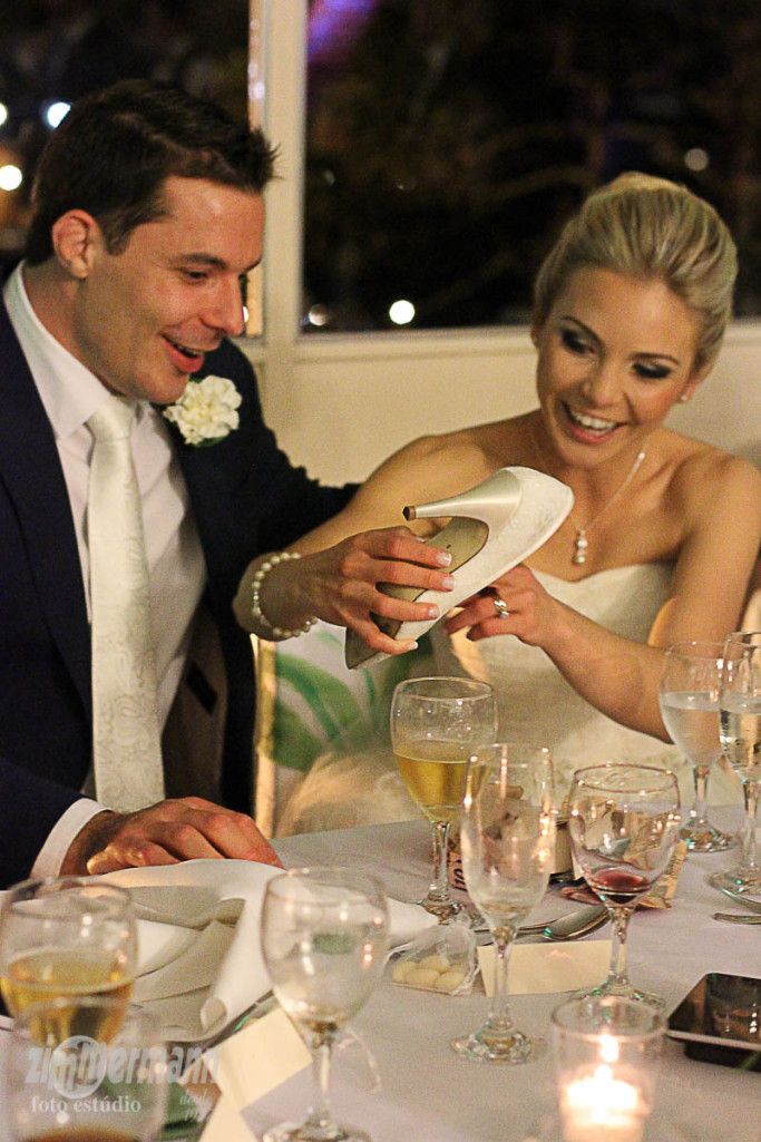 the bride and groom are getting ready to eat their wedding cake at the reception table