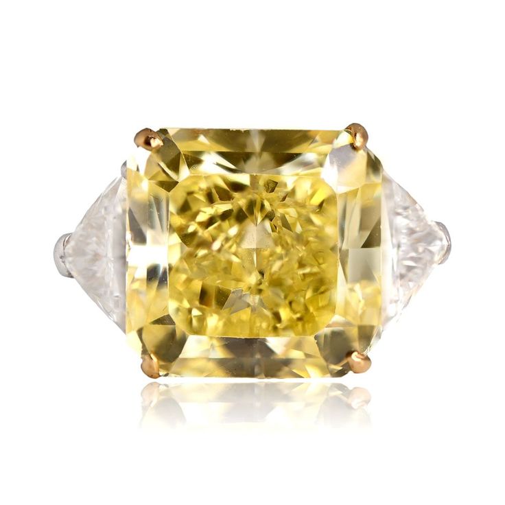 A magnificent fancy color diamond ring that features a GIA-certified 13.15 carat radiant cut Fancy Intense Yellow diamond, VS1 clarity. Flanking the center diamond are two sizable triangle-shaped diamonds. The yellow diamond is set in yellow gold prongs and the ring is platinum.

The GIA certificate states the center diamond weighs 13.15 carats, Fancy Intense Yellow, and VS1 clarity. Diamonds this size and color are very rare.

If you have any questions about the Fremont ring, please feel free to contact us.

 

https://youtu.be/aeZmPhfiMmQ Most Expensive Diamond Ring, Color Diamond Ring, Fancy Color Diamond Ring, Estate Diamond Jewelry, Gia Certificate, Expensive Jewelry, Radiant Cut, Fancy Color Diamonds, Girly Jewelry