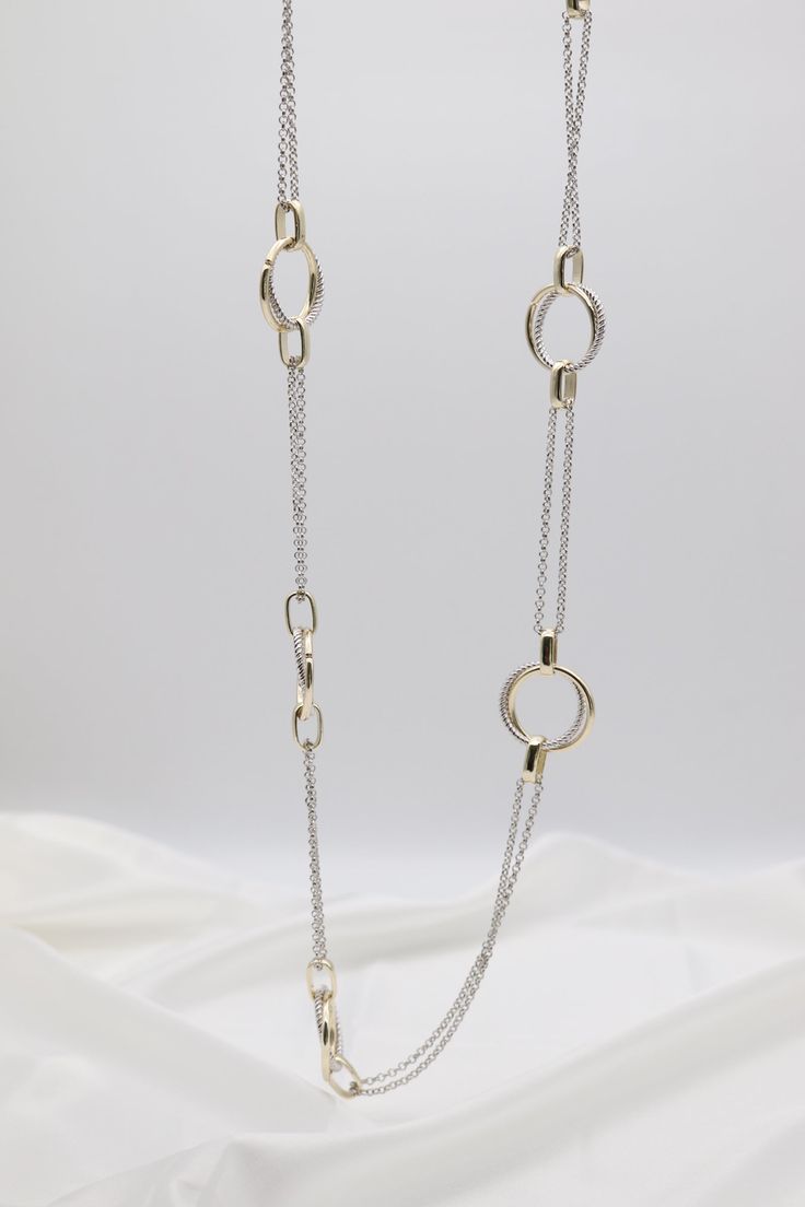 This Gold & Silver Cable Floating Dig Circle Double Belcher Necklace is expertly crafted and designed to elevate any look. Made from high-quality gold and silver, this necklace features a unique floating dig circle design and a double belcher chain for a modern and luxurious touch. A must-have for any jewelry collection. Length: 36 inches Circle: 1.13” Width Closure: Lobster Claw Material: Brass with 18K Gold Plating and Rhodium Coating Lead Free and Hypoallergenic Modern Sterling Silver Necklaces With Double Chain, Modern Sterling Silver Double Chain Necklaces, Modern Sterling Silver Double Chain Necklace, White Gold Necklace With Gold Chain In Sterling Silver, Oval Link Double Chain Metal Necklace, Metal Necklace With Double Oval Link Chain, Metal Double Chain Necklace With Oval Links, Modern White Gold Necklaces With Open Circle, Modern White Gold Necklace With Open Circle Design