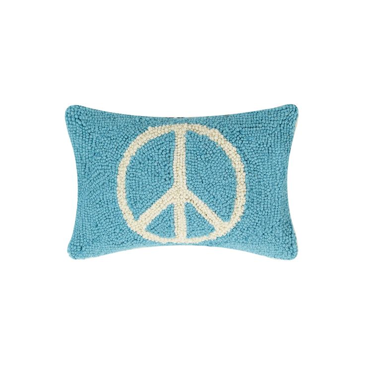 a blue pillow with a peace sign on it