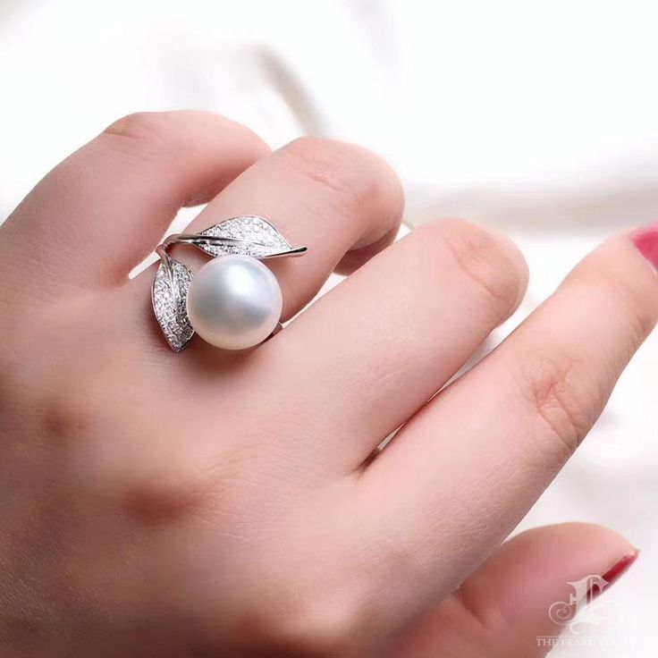 This is a beautiful adjustable ring. Product Information Origin South Sea Pearl Jewelry Processed in Japan Material South Sea Pearl, 18K Gold, and Natural Diamonds Dimensions Adjustable Pearl Shaped: Round Size: 11-12mm Quality: AAAA Nacre: Very Thick Color: White Luster: Very High Accessories Metal: 3.06g of 18k White Gold Other: 0.30ct of SI Quality Natural Diamond Big Pearl Ring, Pearl Ring Design, Antique Ruby Ring, Pearl Diamond Ring, Natural Pearl Ring, Fine Pearl Jewelry, Pearl Chandelier Earrings, White Pearl Ring, South Sea Pearls Earrings