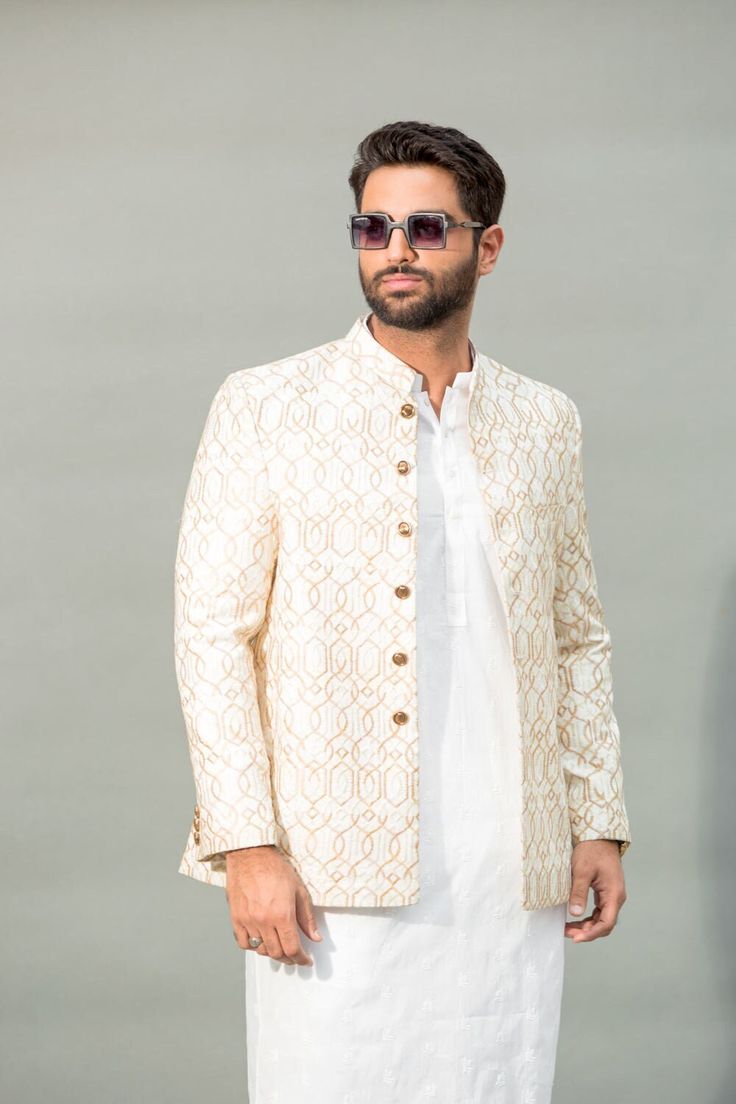 Welcome to Shiraz Saeed Our Retail Store: Rubina's Collection 2070 W Spring creek Pkwy Suite 328 Plano,TX USA 75023 Presenting Men's Off-White Embroidered Jamawar Prince Coat (Kindly provide your size upon checkout) Color: Off-White Premium Embroidered Jamawar Banarsi Fabric Italian Thread Simple & Decent Metal Buttons Finest Stitch Branded Design Custom Sizes are also available. Fit Type: Regular fit Wash Care Instructions: Dry Clean Only Suitable For India Wedding, Festivals And Social Gatherings Disclaimer Due to the photographic lighting & different screen calibrations, the colors of the original product may slightly vary from the picture. Traditional White Long Sleeve Suit, White Outerwear For Eid Wedding, White Outerwear For Wedding And Eid, White Wedding Outerwear For Eid, Fitted Classic Traditional Wear For Wedding, Fitted White Outerwear With Zari Work, Festive White Outerwear With Zari Work, Embroidered Cream Bandhgala For Groom, Formal Embroidered Off White Nehru Jacket